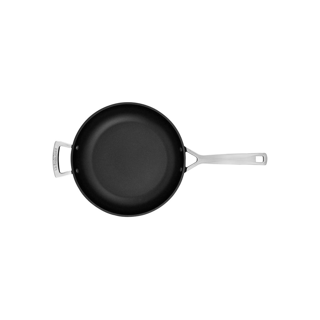 Black frying pan with silver handles on a white background