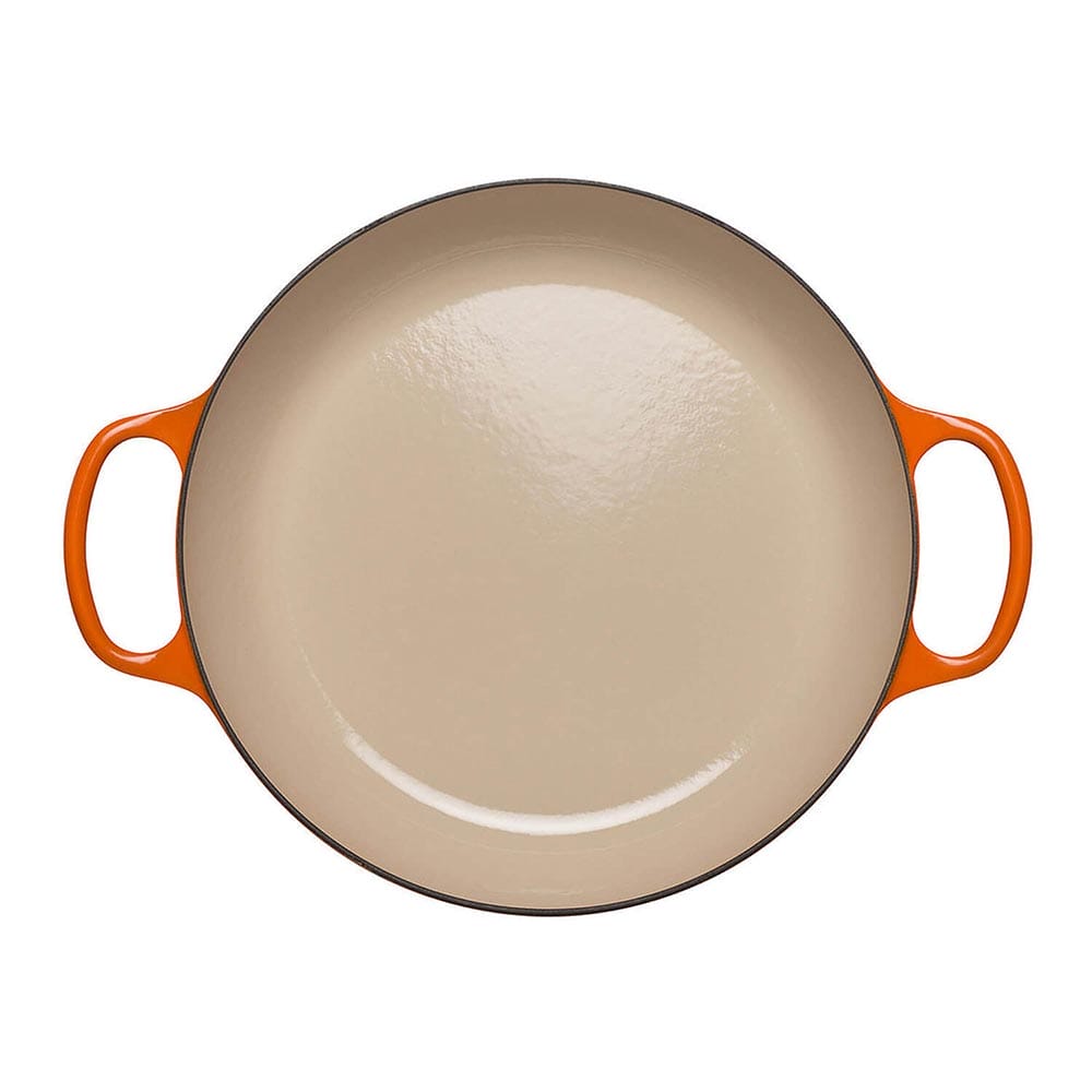Volcanic casserole dish with orange handles on a white background