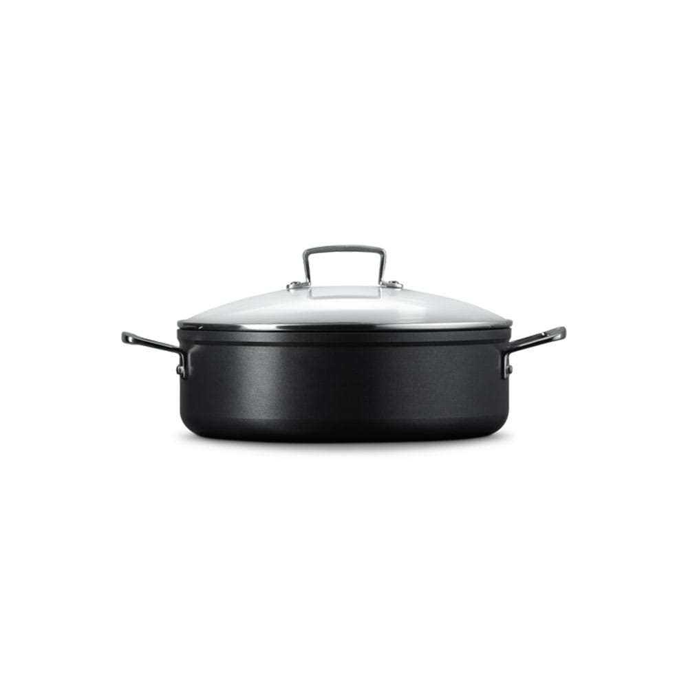 Black sauteuse with a lid on a white background