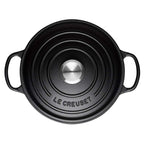 Satin Black Le Creuset casserole on a white background