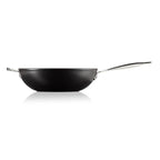 Black stir-fry pan with a silver handle on a white background