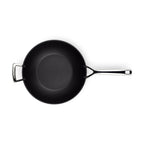 Black stir-fry pan with a silver handle on a white background