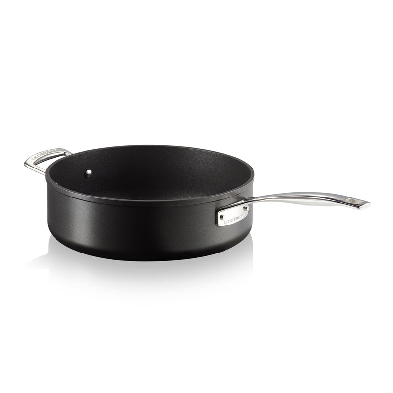 Black frying pan with silver handle on a white background