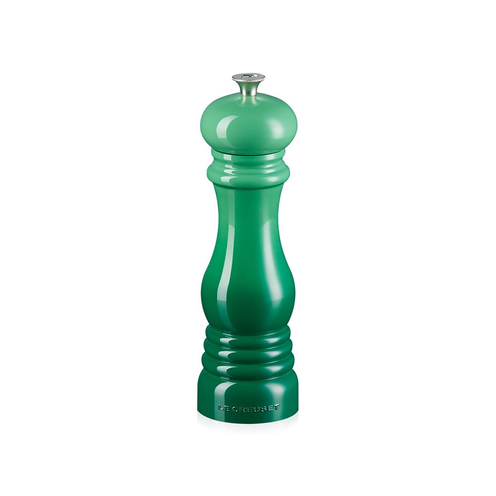 Green pepper mill on a white background
