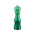 Green pepper mill on a white background
