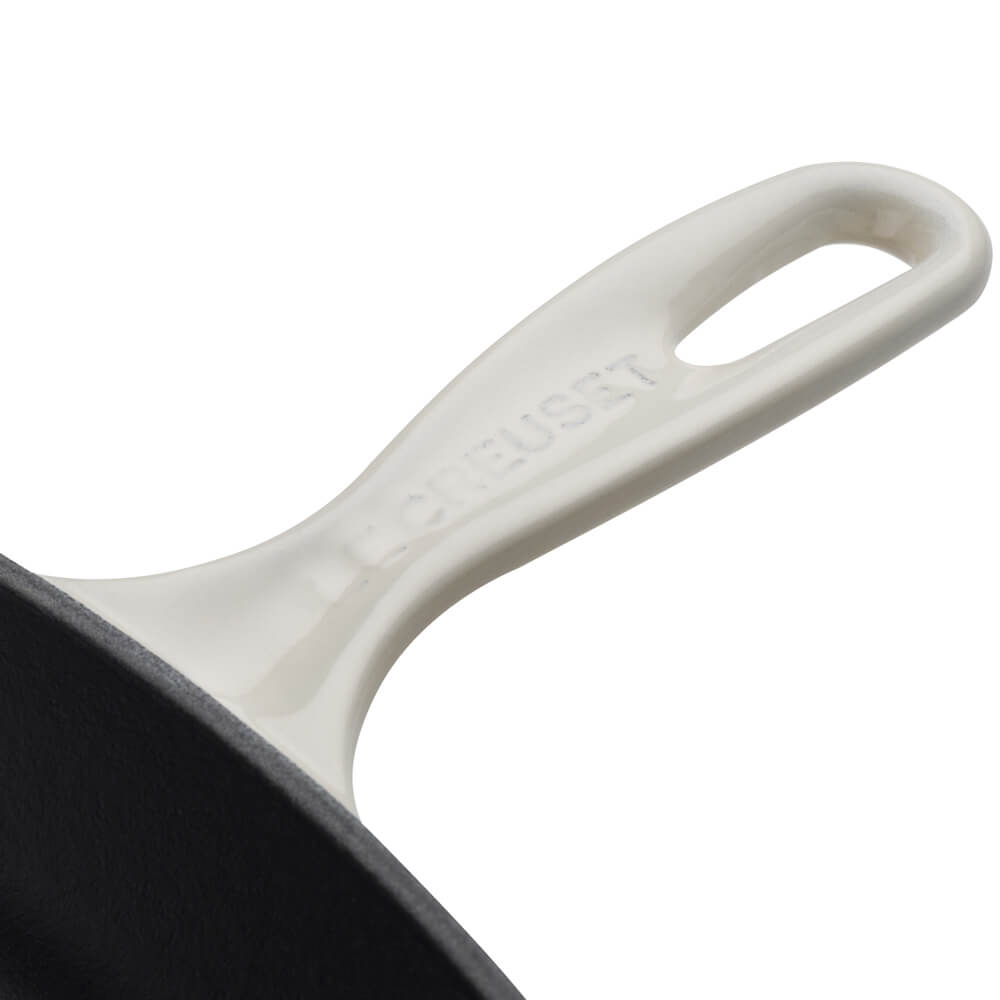 Close-up of a Le Creuset square grillit handle on a white background