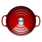 Cerise Le Creuset casserole on a white background