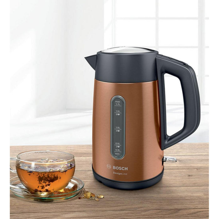 Bosch TWK4P439GB electric kettle on a wooden table with a cup of tea next to it.