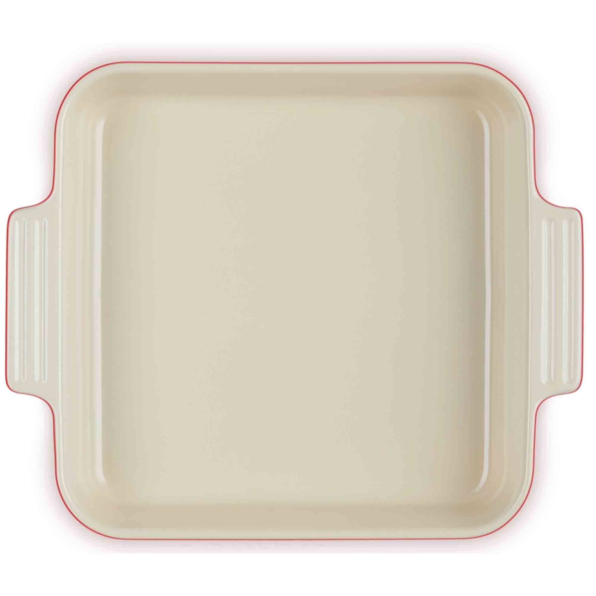 Cerise baking dish with red interior and rim on a white background