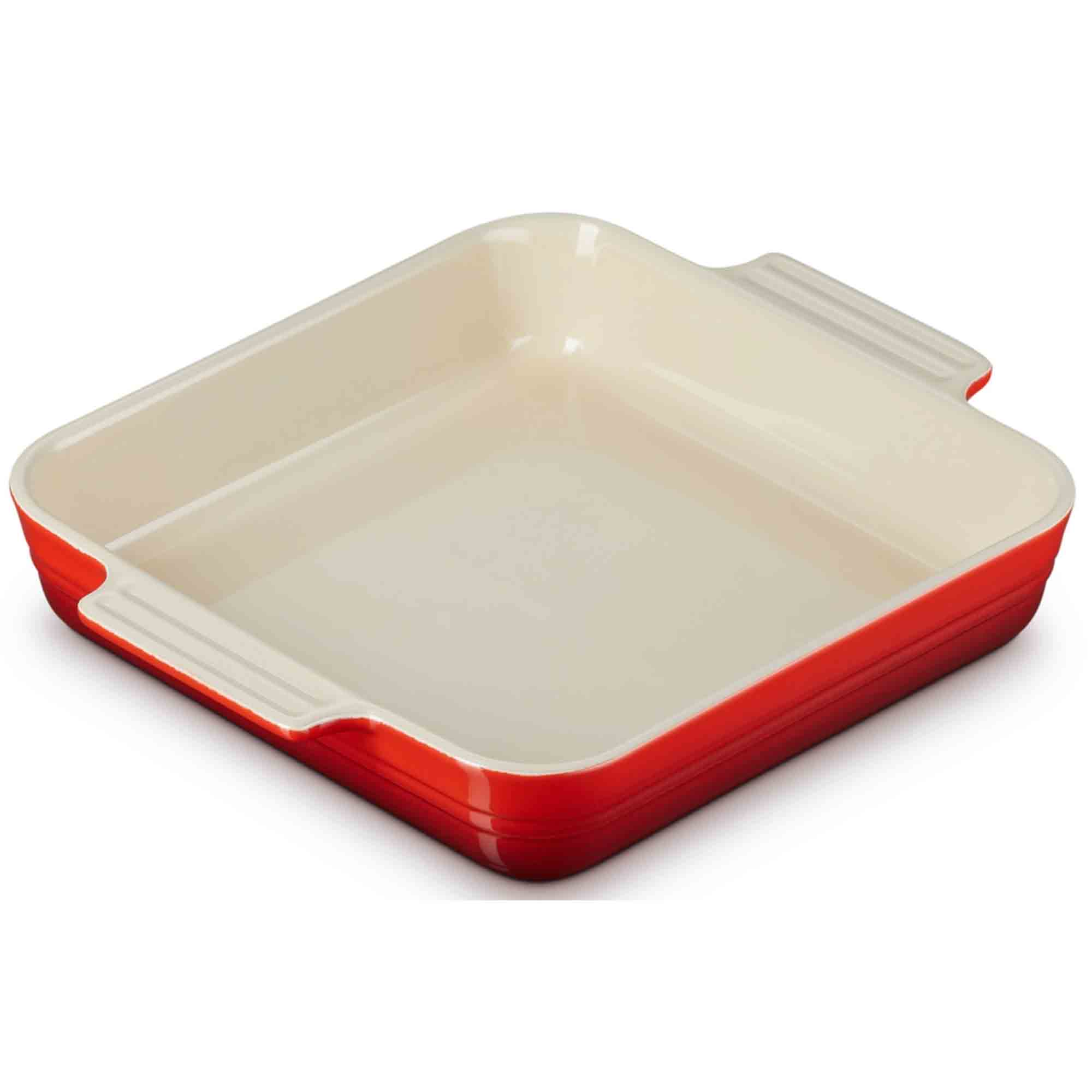 Cerise baking dish with red exterior and beige interior on a white background