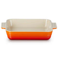 Rectangular baking dish with volcanic bottom and beige top on a white background