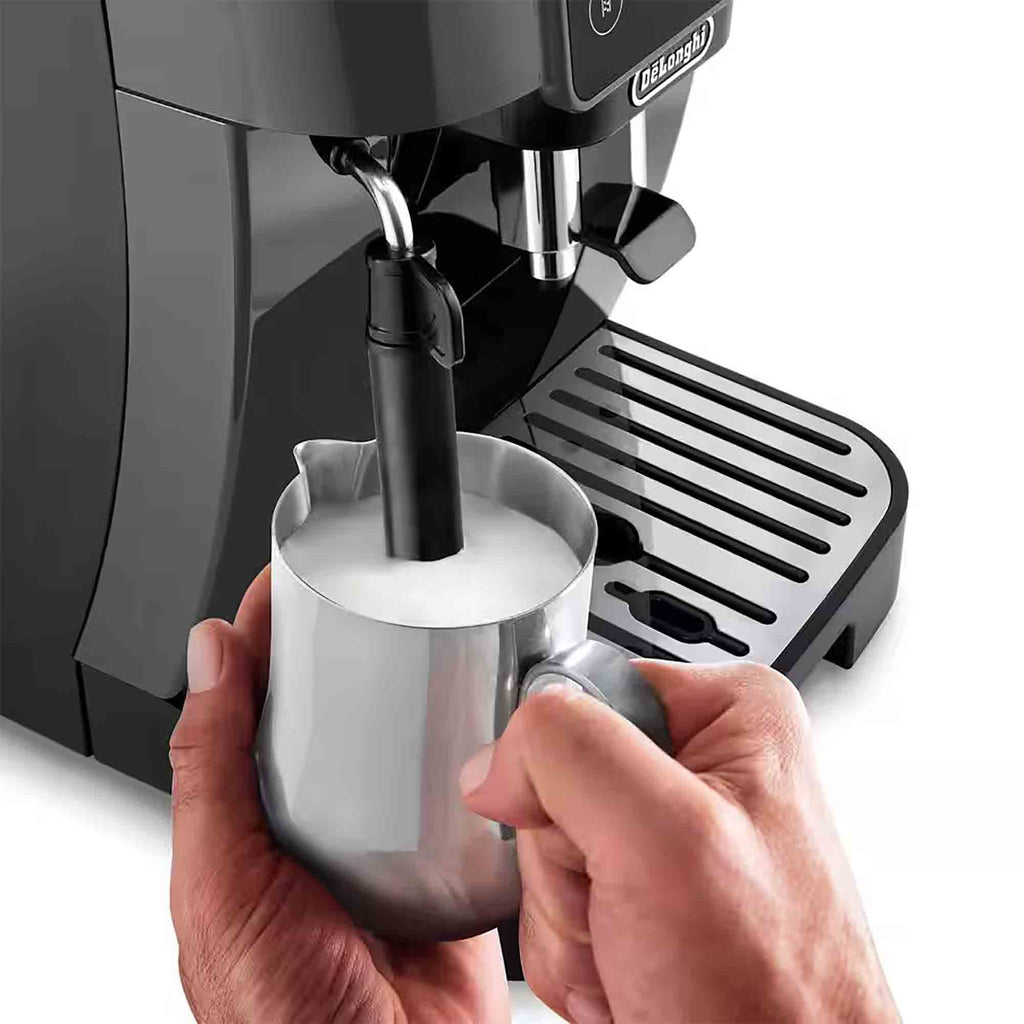 De'Longhi espresso machine with a person holding a milk frothing pitcher.