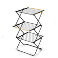 Three-tier metal drying rack with yellow accents on a white background