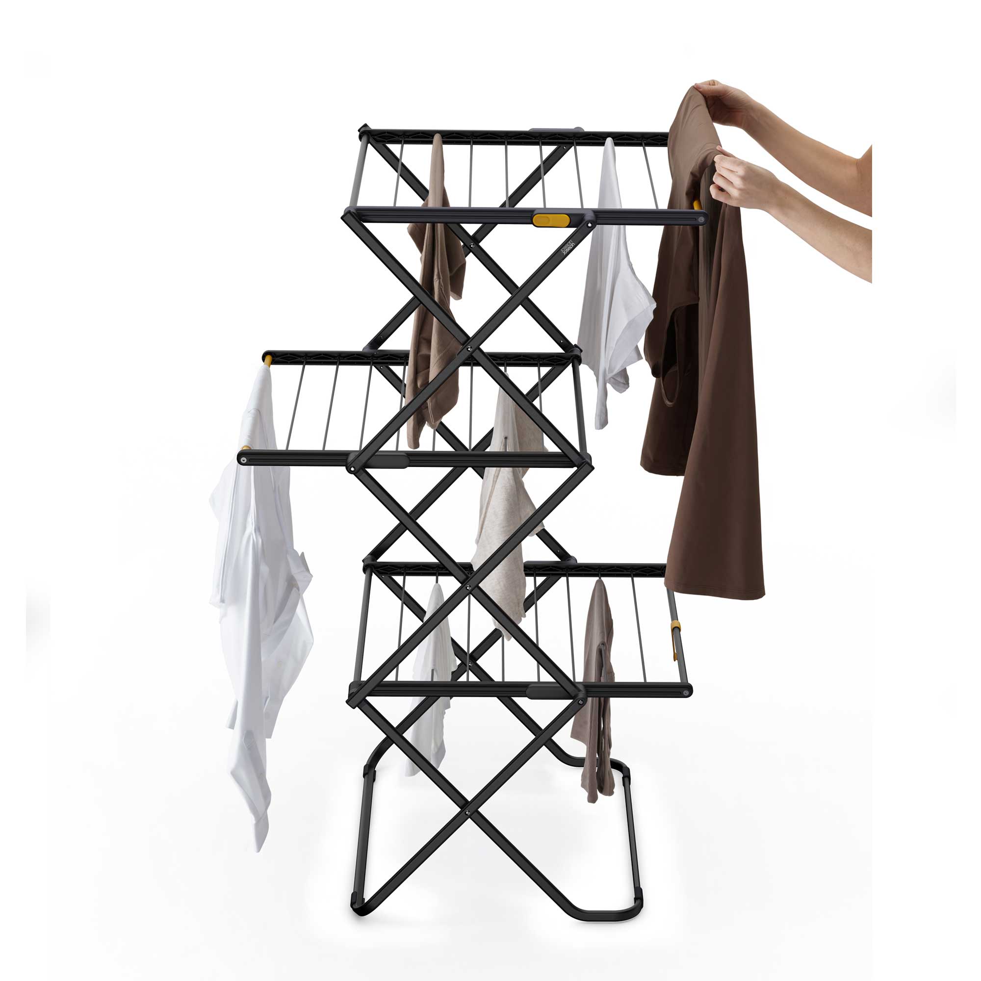 Black metal clothes rack with clothes on a white background