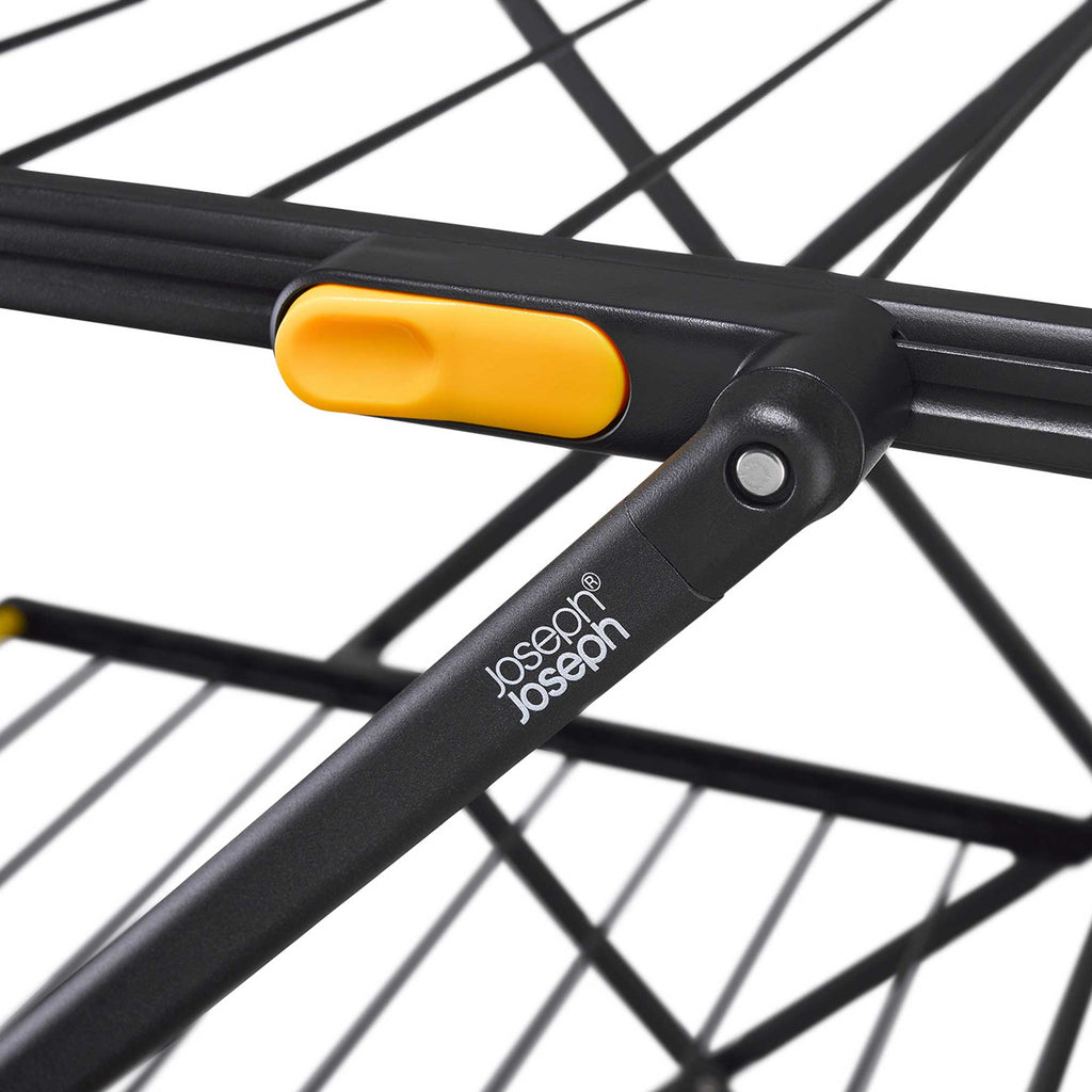 Close-up of a black and yellow metal clothes drier, featuring the Joseph Joseph brand.