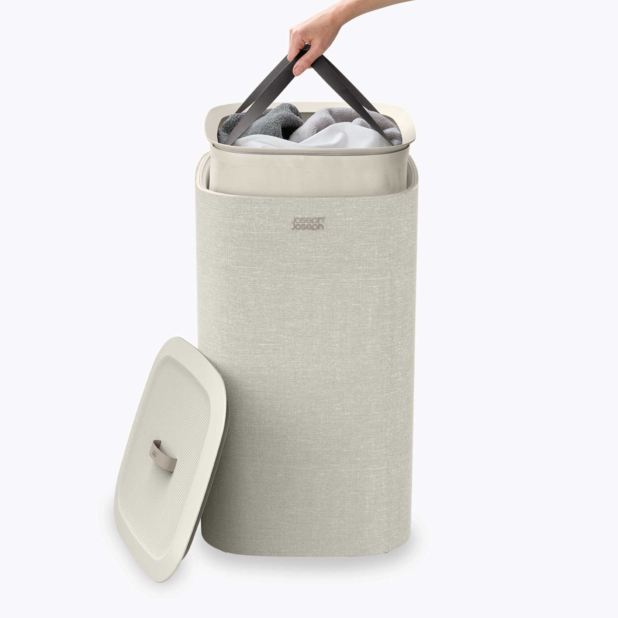 Beige laundry basket with a lid, filled with clothes, on a white background