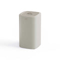 Ecru laundy bin with a lid on a white background