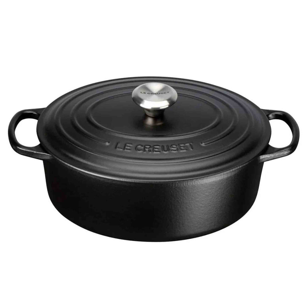 Satin black oval casserole with lid on white background