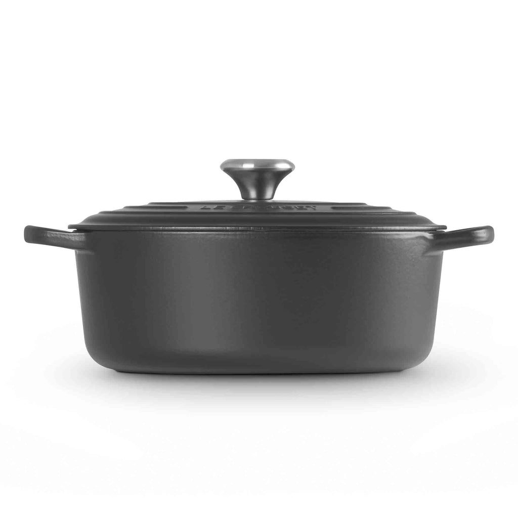 Satin black oval casserole with lid on white background