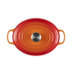 Le Creuset volcanic oval cast iron casserole with lid and handles on white background
