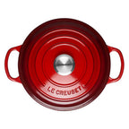 Red Le Creuset casserole on a white background