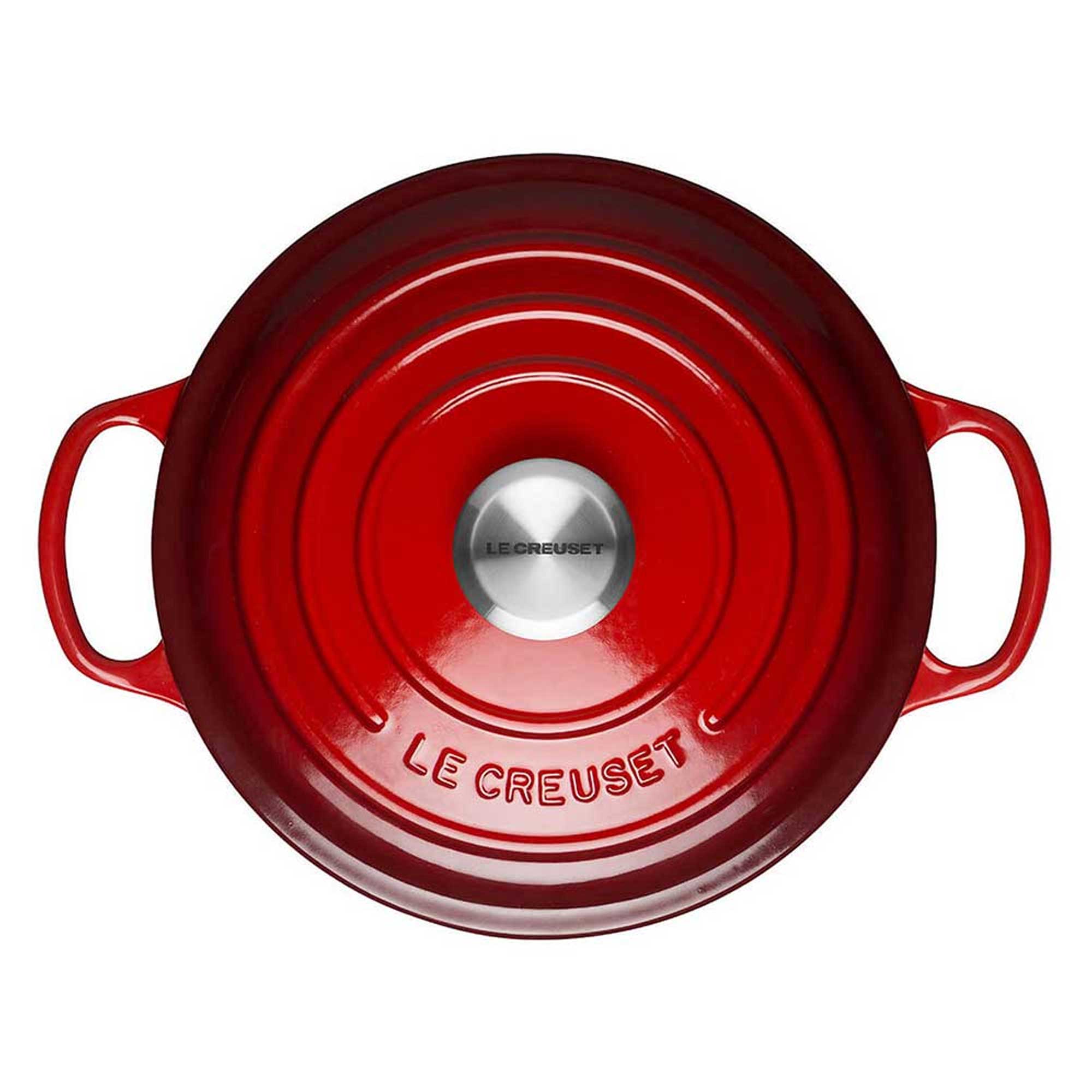 Red Le Creuset casserole on a white background