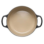 Black enameled cast iron casserole dish on a white background