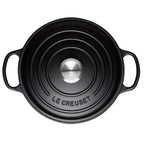 Black Le Creuset pot on a white background