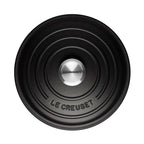 Black round Le Creuset lid branding on a white background