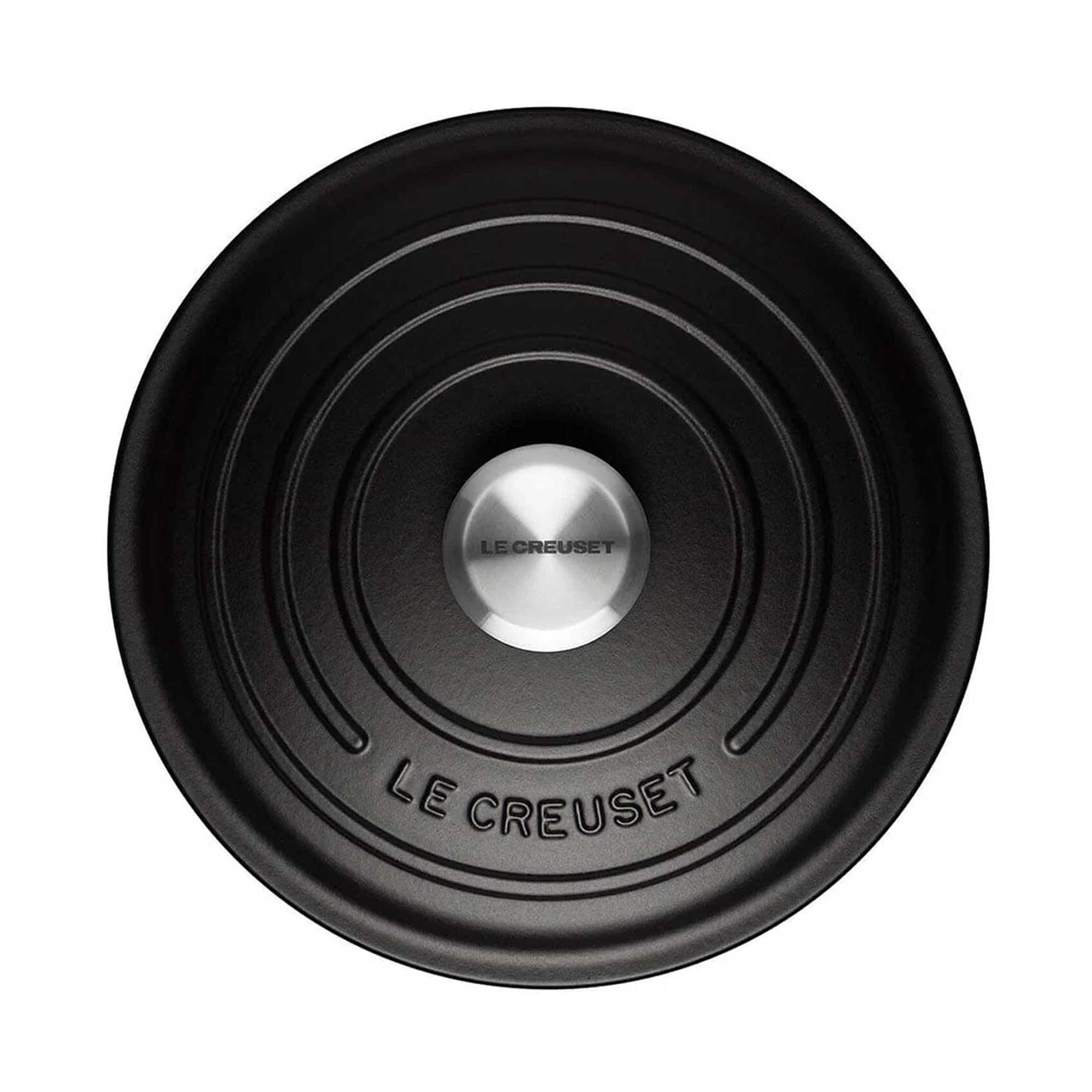 Black round Le Creuset lid branding on a white background