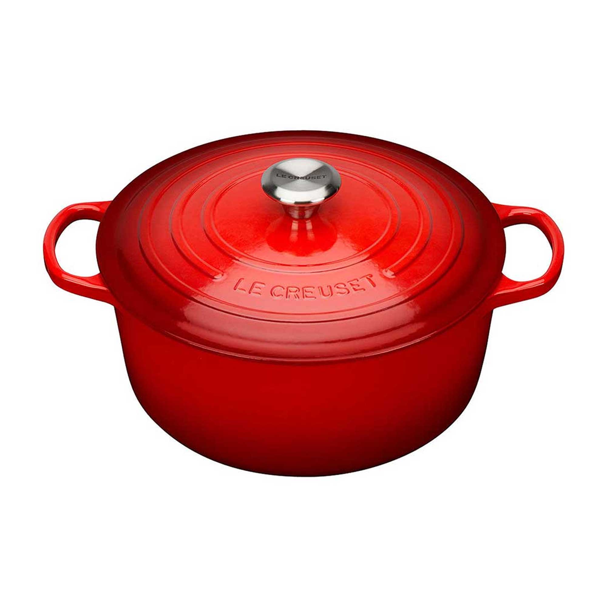 Red Le Creuset pot with a silver lid knob on a white background