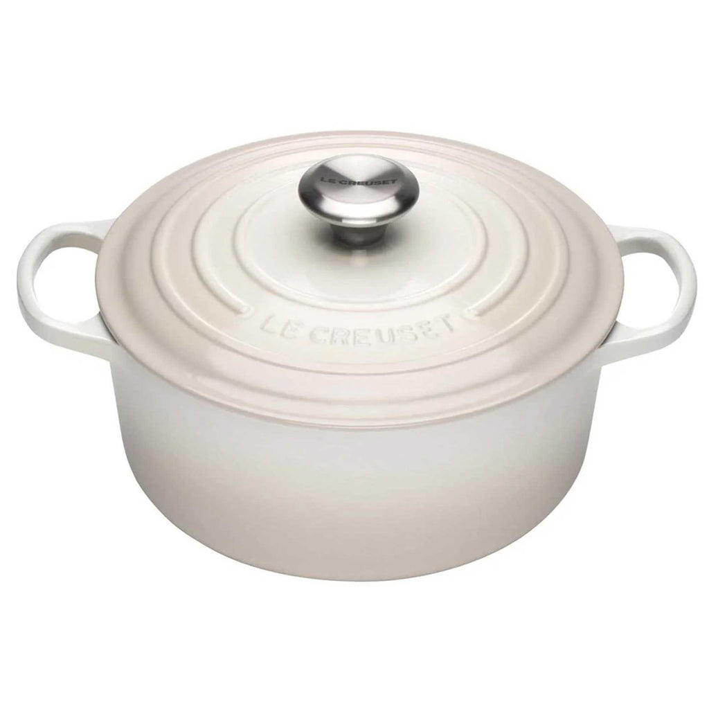 Meringue enameled cast iron Dutch oven with a lid on a white background