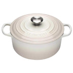 Meringue enameled cast iron Dutch oven with a lid on a white background