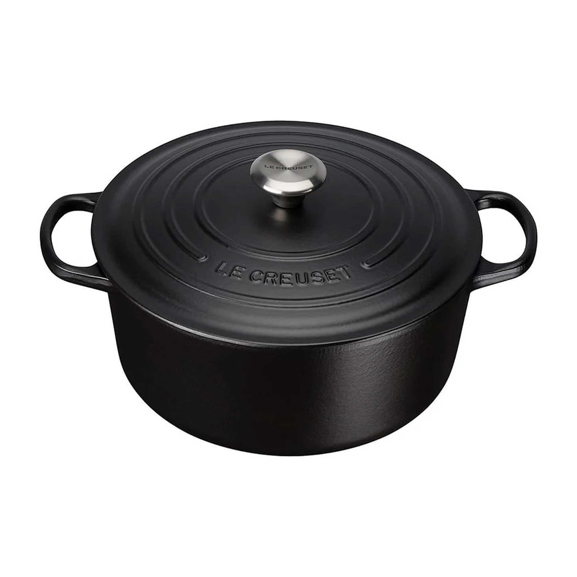 Black cast iron cookware pot with lid on a white background