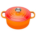 Orange Le Creuset pot with a lid on a white background
