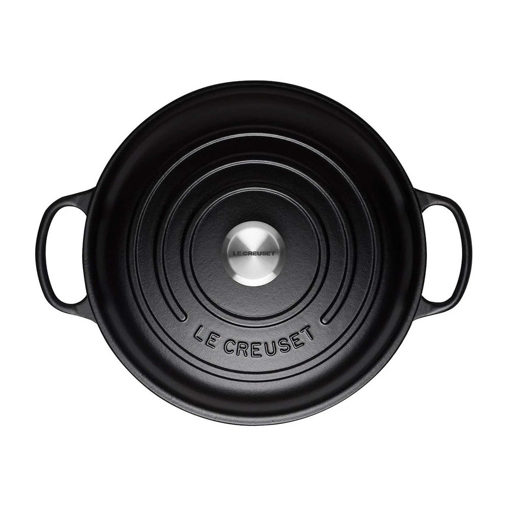 Black Le Creuset pot on a white background