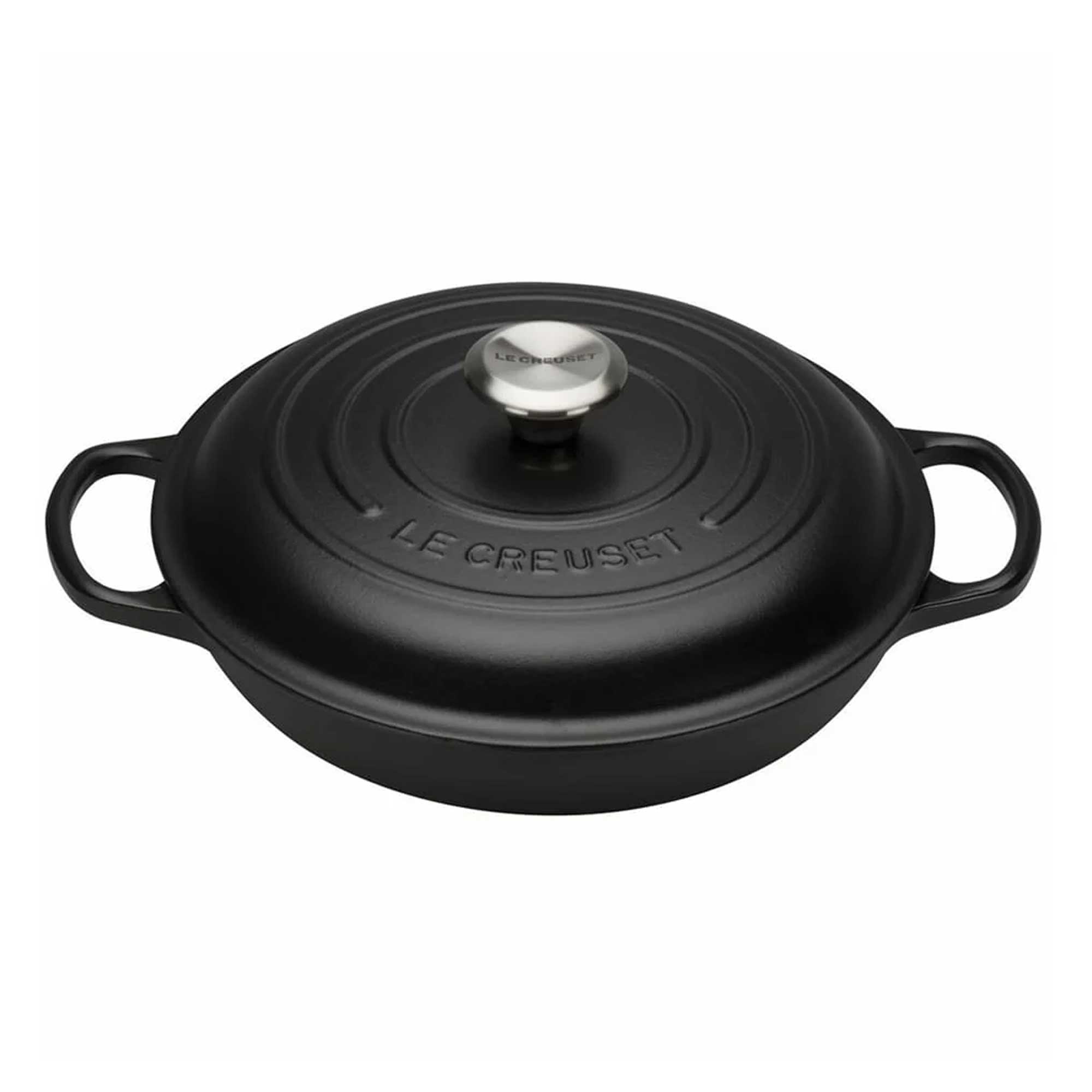 Black cast iron cookware with lid on a white background