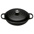 Black Le Creuset cast iron cocotte with lid on a white background