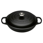 Black Le Creuset cast iron cocotte with lid on a white background