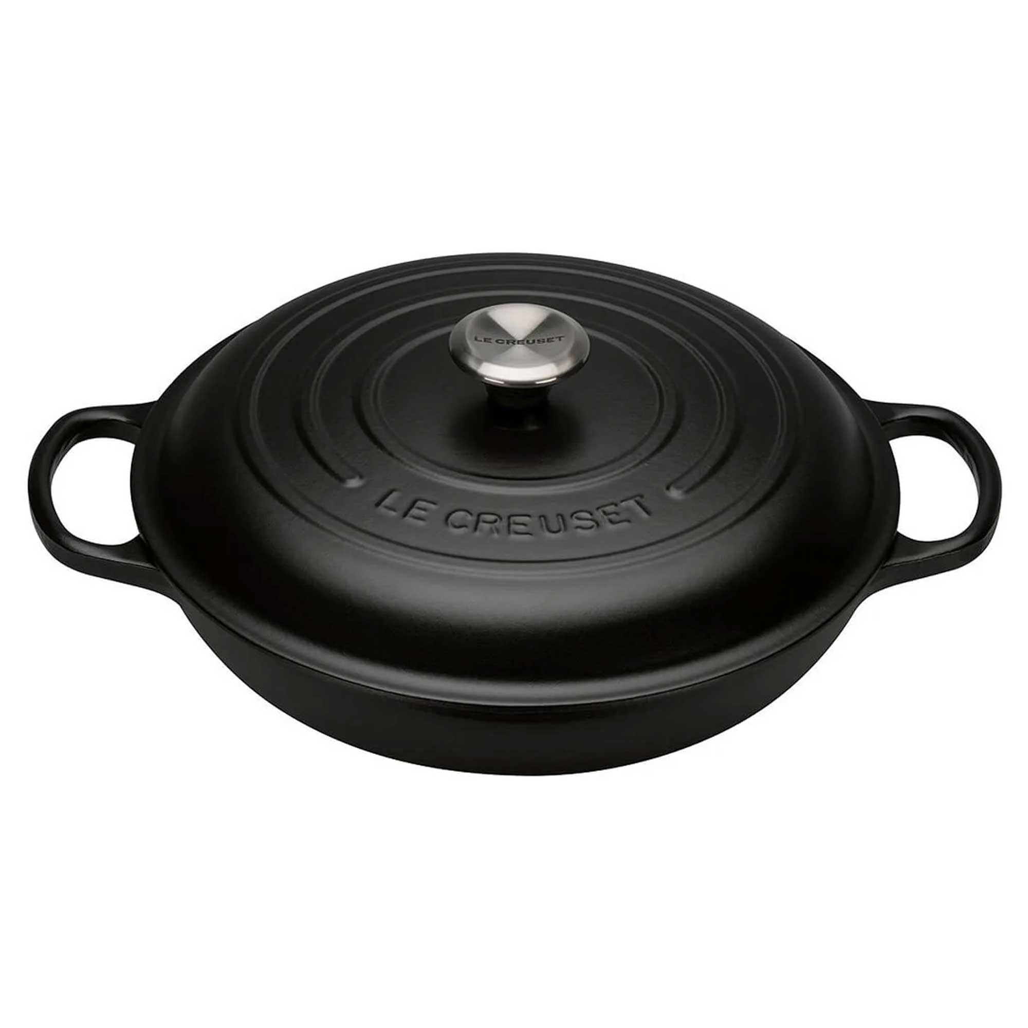 Black Le Creuset cast iron cocotte with lid on a white background