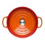 Orange Le Creuset pot on a white background