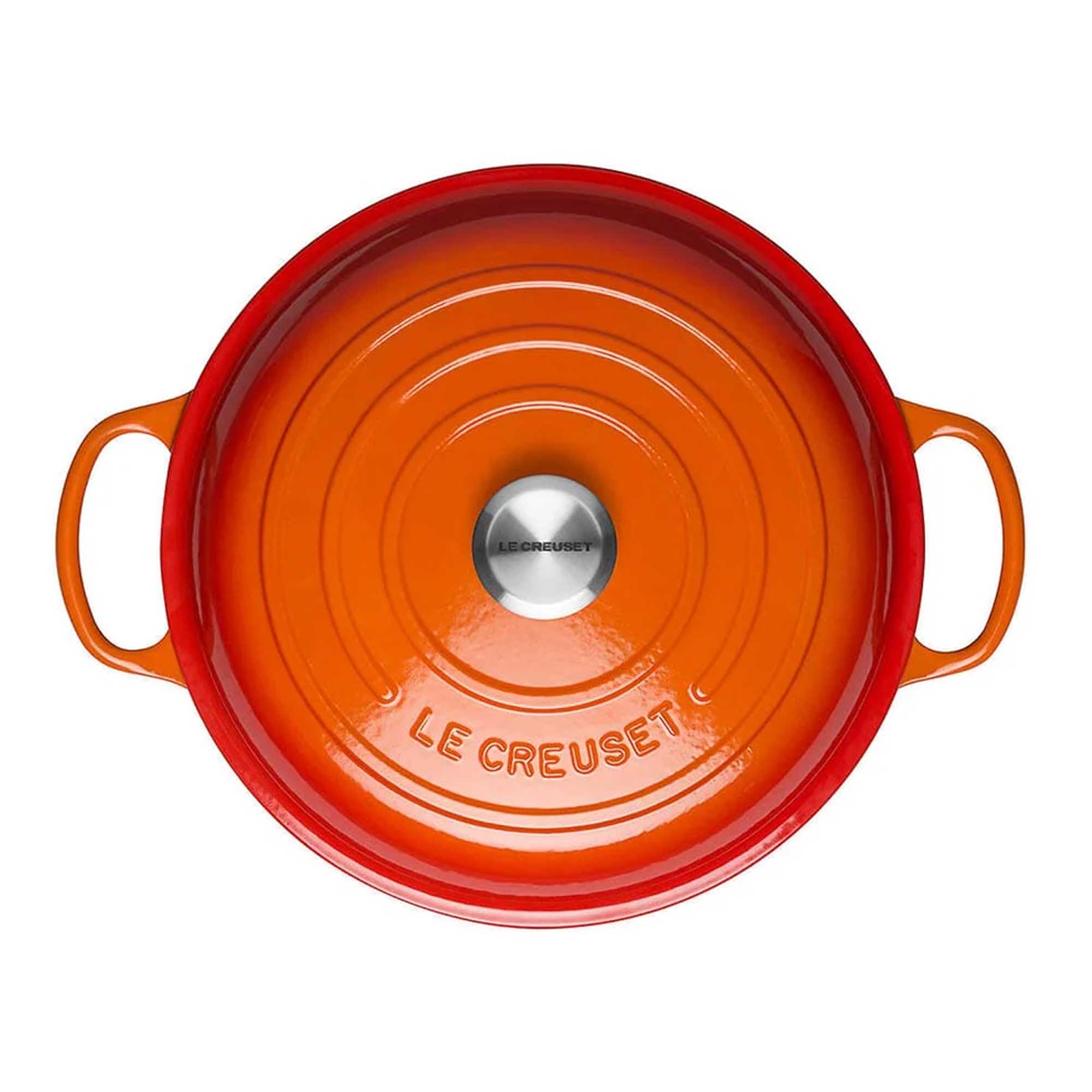 Orange Le Creuset pot on a white background