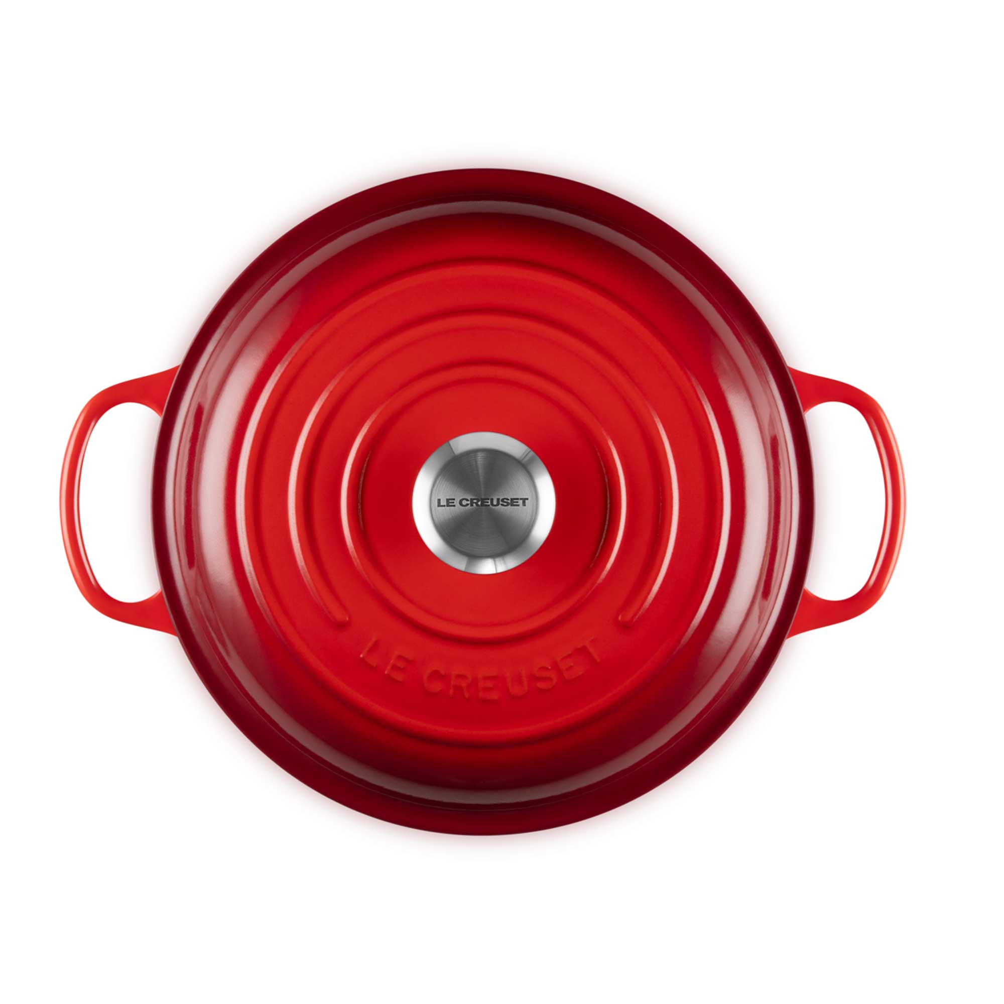 Red Le Creuset lid on a white background