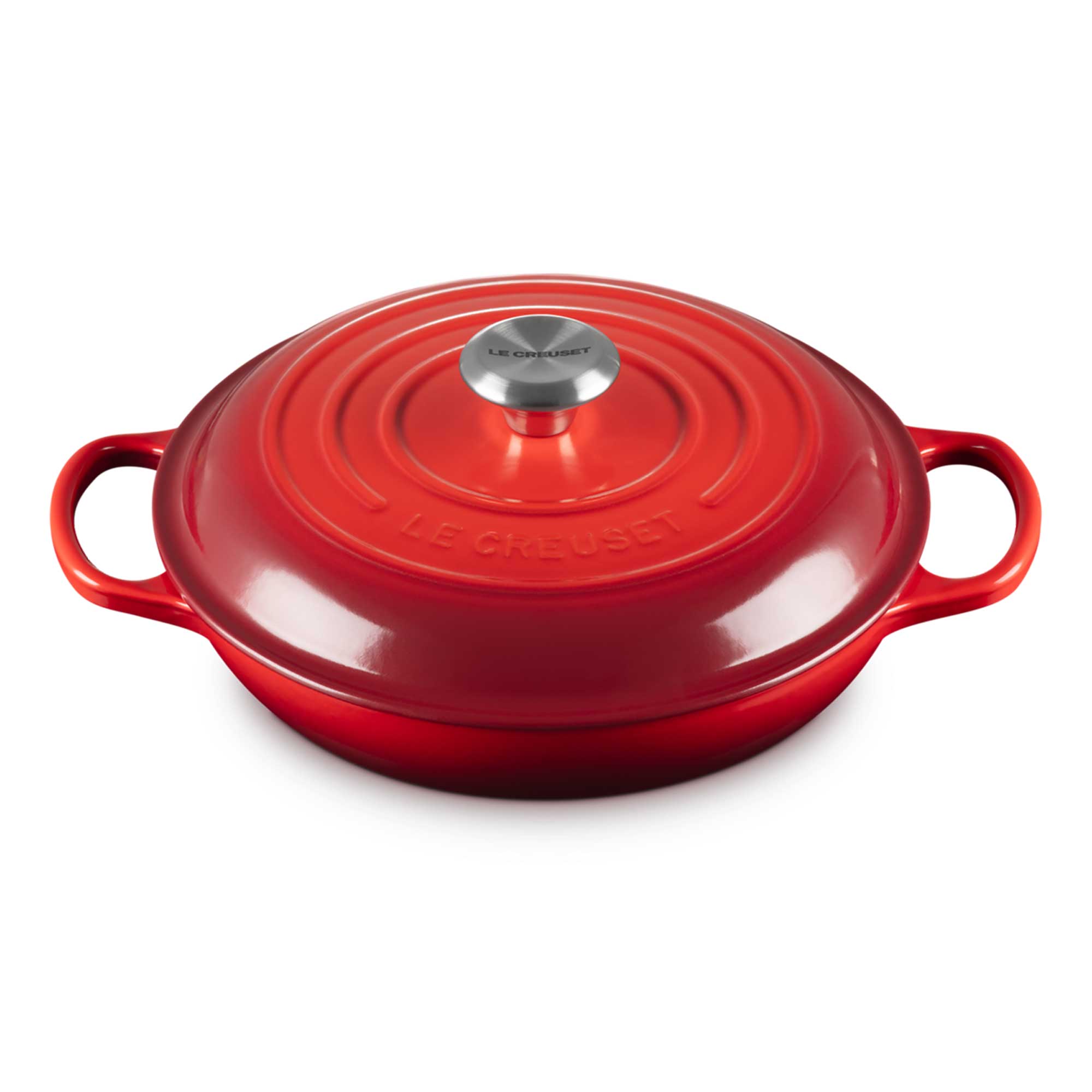 Red cast iron cookware with a silver handle on a white background