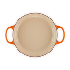Volcanic enameled cast iron casserole with orange handles on a white background