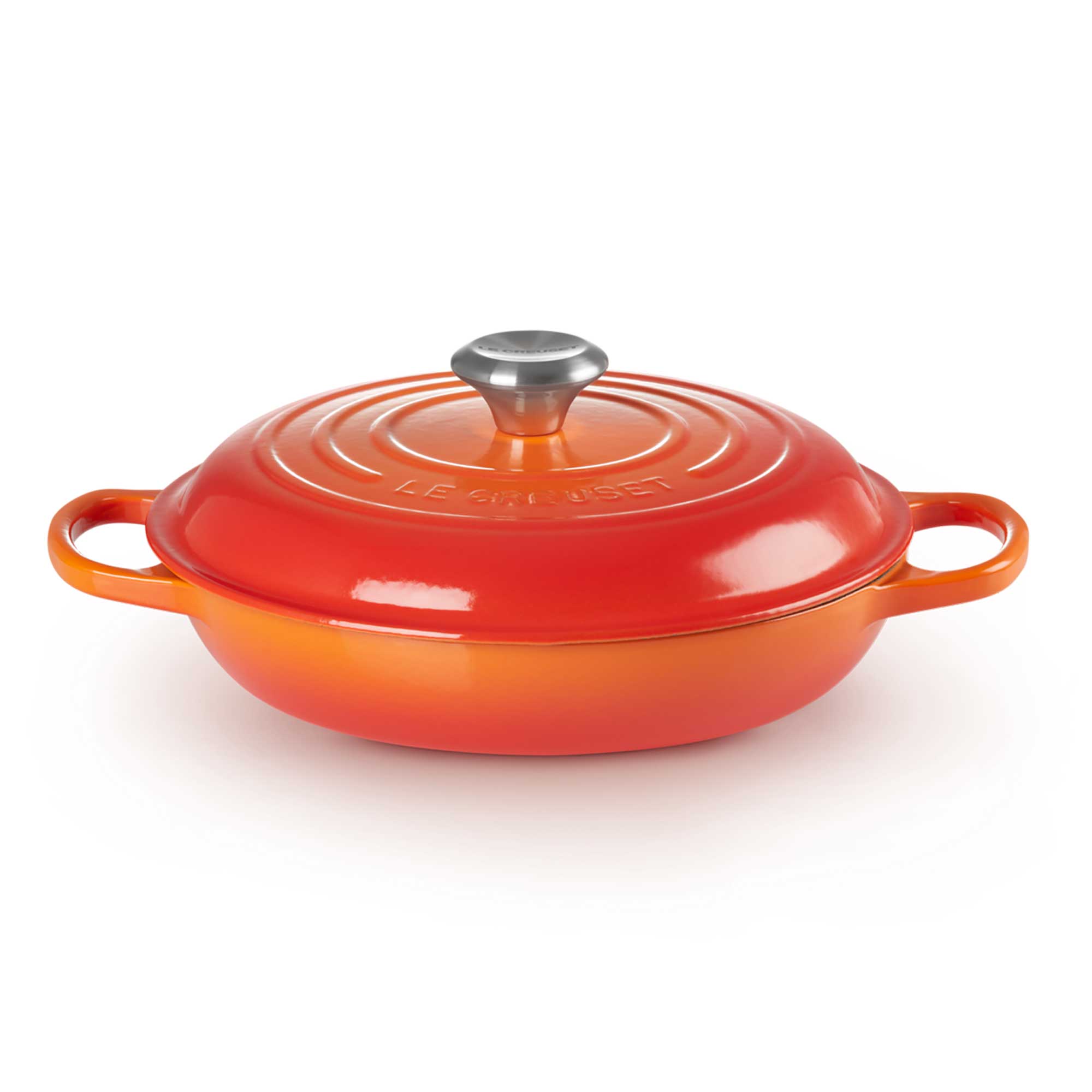 Volcanic enameled cast iron cookware with a silver lid on a white background