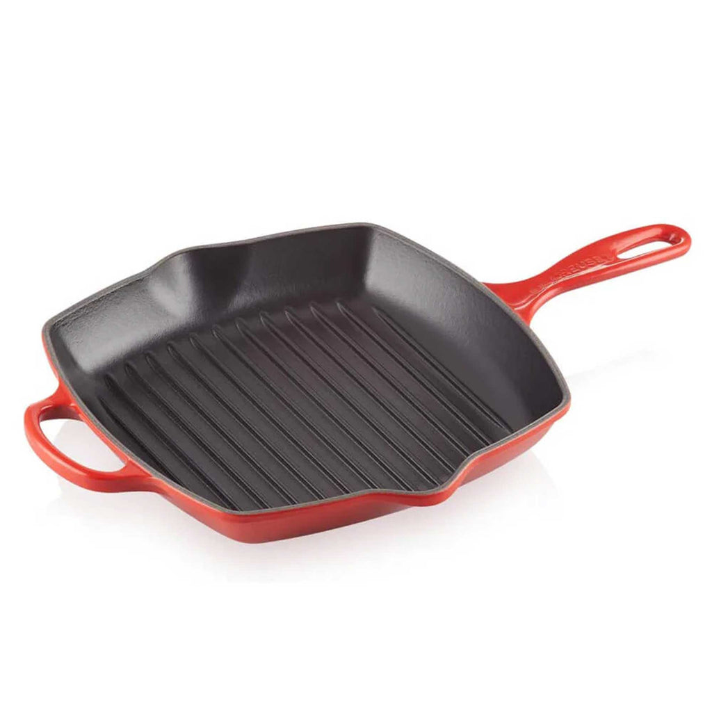 Red cast iron grill pan on a white background
