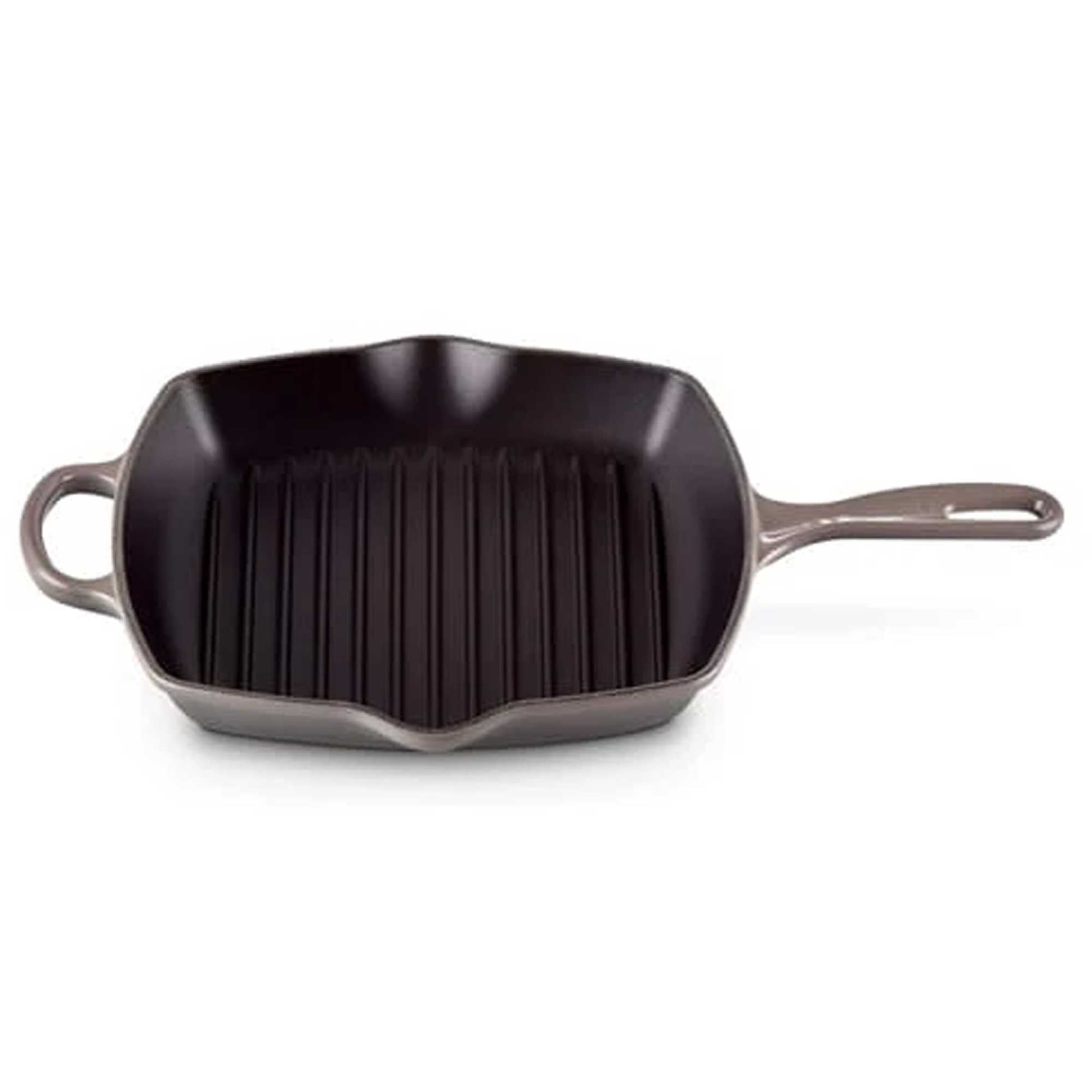 Black cast iron grill pan with handles on a white background