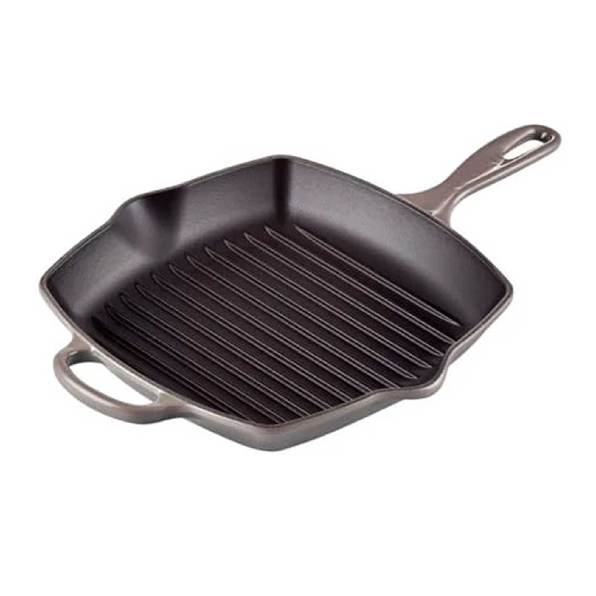 Black cast iron grill pan with handles on a white background