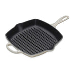 Black grill pan with beige handles on a white background
